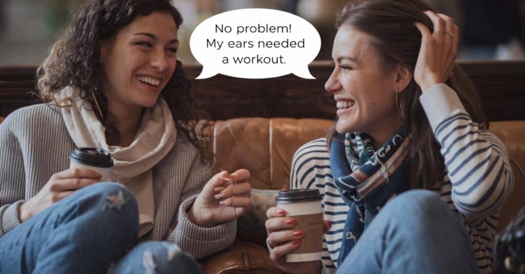 Two friends sharing a playful moment, one laughing while the other says, No problem My ears needed a workout.